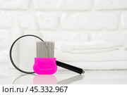 Lice treatment product next to a nit comb and magnifying glass. Стоковое фото, фотограф Сергей Толмачёв / Фотобанк Лори