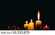 Burning candles and flowers on black background with space for text an obituary, list of dead. Funeral concept. Стоковое AI-изображение, AI-художник Павел Муравьев / Фотобанк Лори