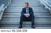 Disheartened businessman seated on steps, embodying bankruptcy and business failure, aura of defeat and exhaustion. Стоковое AI-изображение, AI-художник Павел Муравьев / Фотобанк Лори