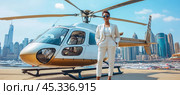 Businesswoman standing near helicopter in new york city manhattan heliport. Стоковое AI-изображение, AI-художник Юрий Поздников / Фотобанк Лори