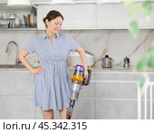 Housewife does cleaning in room - vacuums and dusts. Стоковое фото, фотограф Яков Филимонов / Фотобанк Лори