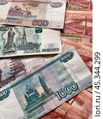Close-up of Russian rubles. Ruble banknotes of different denominations are scattered on the table. Money financial background. Flat lay, close-up, top view. Стоковое фото, фотограф Виктория Катьянова / Фотобанк Лори