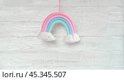 Soft Cotton Rainbow Toy on a Wooden White Wall. Baby Child Mockup for Design Presentation, Minimal Composition. Free Space For Text. Boho Kids Decoration. Accessories for Birthday Party. Macrame Knit. Стоковое видео, видеограф Марина Демидюк / Фотобанк Лори