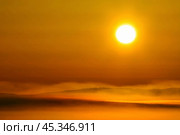 Beautiful sunrise over the tundra. Early morning in May. Over the Anadyr estuary clubs of fog rise. The large disk of the sun colors the atmosphere in golden color. Chukotka, the Far East of Russia. Стоковое фото, фотограф Андрей Степанов / Фотобанк Лори
