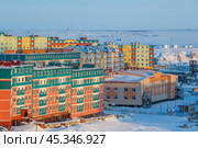 Winter aerial view of a city in the Arctic. View of the colorful residential buildings and the kindergarten building. Snow-covered tundra in the distance. Cold weather. Anadyr, Chukotka, Russia. Стоковое фото, фотограф Андрей Степанов / Фотобанк Лори