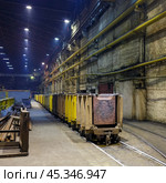 Copper production at the metallurgical plant. Metal sheets on trolleys. Industrial narrow gauge railway in a large factory room. Norilsk, Krasnoyarsk Region, Russia. Редакционное фото, фотограф Андрей Степанов / Фотобанк Лори