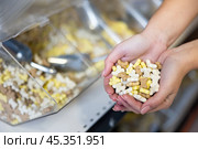 Female hands with handful of snacks for dogs at pet store. Стоковое фото, фотограф Яков Филимонов / Фотобанк Лори
