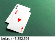 Cards and chips for poker on green table. Стоковое фото, фотограф Сергей Толмачёв / Фотобанк Лори
