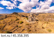 Aerial drone view of famous Vahramashen Church of the 11th century, located near destroyed Amberd fortress in sunny summer day. Cliff with Arkashian River deep in canyon. Aragatsotn region, Armenia. Стоковое фото, фотограф Алексей Ширманов / Фотобанк Лори