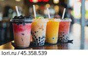 Boba tea drinks standing on a countertop. Стоковое видео, видеограф Данил Руденко / Фотобанк Лори