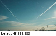 Chemtrail conspiracy theory. Long-lasting condensation trails left in sky by high-flying aircraft are actually chemtrails consisting of chemical or biological agents, sprayed for nefarious purposes. Стоковое AI-изображение, AI-художник Юлия Петровская / Фотобанк Лори