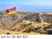 Aerial drone view to flag of Armenia and famous Vahramashen Church of the 11th century, near Amberd fortress in sunny summer day. Cliff with Arkashian River deep in canyon. Aragatsotn region, Armenia. Стоковое фото, фотограф Алексей Ширманов / Фотобанк Лори