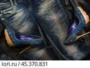Jeans and denim shoes encrusted with crystals on black silk. Стоковое фото, фотограф Александр Собко / Фотобанк Лори