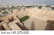 Scenic view from watchtower at Ribat of Monastir to inner courtyard of ancient fortress with preserved stone structures and modern urban landscape of coastal Mediterranean city on sunny day, Tunisia. Стоковое видео, видеограф Яков Филимонов / Фотобанк Лори