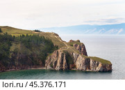 Baikal Lake in August day. View of rocky cape Three Brothers or Saga-Khushun cliff - popular place for tourists and natural landmark of Olkhon Island. Scenic landscape. Summer holidays and travels. Стоковое фото, фотограф Виктория Катьянова / Фотобанк Лори
