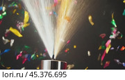 Party cannon launching confetti on black background. Стоковое видео, видеограф Данил Руденко / Фотобанк Лори