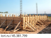 Close-up of the hous wooden formwork anchored to the foundation. Building a house in the countryside. Стоковое фото, фотограф Коханова Наталья / Фотобанк Лори