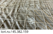 A grey tarp is laying on a concrete floor. Стоковое фото, фотограф Скрипачев Антон / Фотобанк Лори