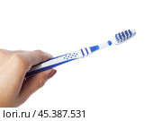 Woman hand holding a toothbrush isolated on white. Стоковое фото, фотограф Сергей Толмачёв / Фотобанк Лори