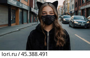 Quadrober. A girl in a cat outfit on a city street. Imitation of animal movement. Trends in teenage lifestyle, the impact of social networks on young people. Стоковое AI-изображение, AI-художник Photojuli / Фотобанк Лори