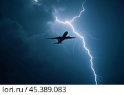 The aircraft encounters a severe thunderstorm, surrounded by dark clouds and illuminated by bright lightning strikes, highlighting the danger in the sky. Causes of air crashes. Generative AI. Стоковое AI-изображение, AI-художник Юлия Петровская / Фотобанк Лори