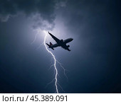 The aircraft encounters a severe thunderstorm, surrounded by dark clouds and illuminated by bright lightning strikes, highlighting the danger in the sky. Causes of air crashes. Generative AI. Стоковое AI-изображение, AI-художник Юлия Петровская / Фотобанк Лори