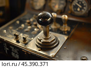 Shiny chrome throttle lever standing on metal control panel. Стоковое AI-изображение, AI-художник Иван Рябоконь / Фотобанк Лори