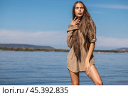 Portrait of a young brunette woman posing in beige tunic. Стоковое фото, фотограф Андрей Аркуша / Фотобанк Лори