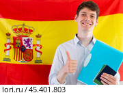 Young guy posing with documents on background of flag of Spain. Стоковое фото, фотограф Татьяна Яцевич / Фотобанк Лори