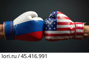Боксерские перчатки в цветах флагов России и США. Концепция противостояния государств. Стоковое AI-изображение, AI-художник Илья Старков / Фотобанк Лори