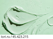 Color correcting concealer stroke. Mint green corrector cream smudge swatch sample. Makeup base foundation creamy texture. Beauty industry, cosmetics. Smooth cosmetic smear of pastel green cream. Стоковое AI-изображение, AI-художник Марина Демидюк / Фотобанк Лори