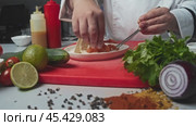 The chef cooked salmon with tortilla and cheese. This dish is a Mexican taco, but with the addition of fish. Стоковое видео, видеограф Strunov David / Фотобанк Лори
