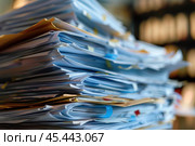 Stack of documents piling up on a desk. Стоковое AI-изображение, AI-художник Иван Рябоконь / Фотобанк Лори