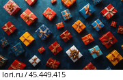 Luxurious dark blue provides the perfect stage for a scattering of brightly wrapped gifts. Стоковое AI-изображение, AI-художник Ярославский Максим / Фотобанк Лори