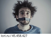 Shaggy, frightened man with his mouth taped shut. Стоковое AI-изображение, AI-художник Дмитрий Киселёв / Фотобанк Лори