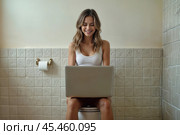 Young pretty woman has retired to the toilet and is working on her laptop. Стоковое AI-изображение, AI-художник Дмитрий Киселёв / Фотобанк Лори