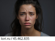 Portrait of a crying caucasian girl with bruised skin on grey studio background. Domestic violence, portrait of abused and hurt young woman crying at home. Sadness and depression concept. Стоковое AI-изображение, AI-художник Sergey Grishin / Фотобанк Лори