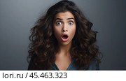 portrait of Surprised, shocked, excited Hispanic young adult curly woman with open mouth isolated on grey background. Winner concept, celebration for deal, retail sale, discount news, unexpected prize. Стоковое AI-изображение, AI-художник Sergey Grishin / Фотобанк Лори