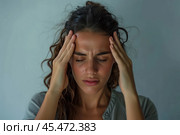 Close up unhealthy young woman suffering from strong headache or chronic migraine, touching temples with closed eyes, unhappy tired businesswoman or student feeling unwell, feeling pain. Стоковое AI-изображение, AI-художник Sergey Grishin / Фотобанк Лори