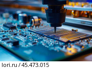Automatic Pick and Place machine quickly installs Components on Generic Circuit Board. Electronics and Circuit board Manufacturing. Bright Environment. Стоковое AI-изображение, AI-художник Sergey Grishin / Фотобанк Лори
