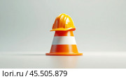 The construction helmet is worn on a restrictive cone. A symbol of safety during construction work. Стоковое AI-изображение, AI-художник Ярославский Максим / Фотобанк Лори
