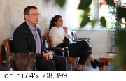 Serious-minded male candidate siting on chair and waiting for job interview in hallway. Стоковое видео, видеограф Яков Филимонов / Фотобанк Лори