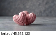 The banner. Background for Valentine's Day. Knitted hearts with festive lights in the form of a side in the background. a mock-up of an invitation card for a Valentine's Day party, a place to copy. Стоковое AI-изображение, AI-художник Photojuli / Фотобанк Лори