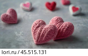 The banner. Background for Valentine's Day. Knitted hearts with festive lights in the form of a side in the background. a mock-up of an invitation card for a Valentine's Day party, a place to copy. Стоковое AI-изображение, AI-художник Photojuli / Фотобанк Лори