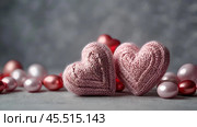 The banner. Background for Valentine's Day. Knitted hearts with festive lights in the form of a side in the background. a mock-up of an invitation card for a Valentine's Day party, a place to copy. Стоковое AI-изображение, AI-художник Photojuli / Фотобанк Лори