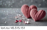 The banner. Background for Valentine's Day. Knitted hearts with festive lights in the form of a side in the background. a mock-up of an invitation card for a Valentine's Day party, a place to copy. Стоковое AI-изображение, AI-художник Photojuli / Фотобанк Лори