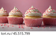 Festive cupcakes, baked with pastry sprinkles on a pink background with sequins, ideal for romantic celebrations. Valentine's Day, wedding. Стоковое AI-изображение, AI-художник Photojuli / Фотобанк Лори