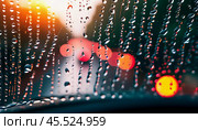 Raindrops cling to the surface of car glass, distorting a vibrant cityscape at evening, where colorful lights from traffic and buildings merge into a beautiful display. Generative AI. Стоковое AI-изображение, AI-художник Юлия Петровская / Фотобанк Лори
