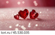 A banner for Valentine's Day. Crystal red hearts with festive lights in the form of a side in the background. A mock-up of an invitation card for a Valentine's Day party, a place to copy. Стоковое AI-изображение, AI-художник Photojuli / Фотобанк Лори