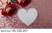 A banner for Valentine's Day. A red heart and roses with festive lights in the form of a side in the background. A mock-up of an invitation card for a Valentine's Day party, a place to copy. Стоковое AI-изображение, AI-художник Photojuli / Фотобанк Лори